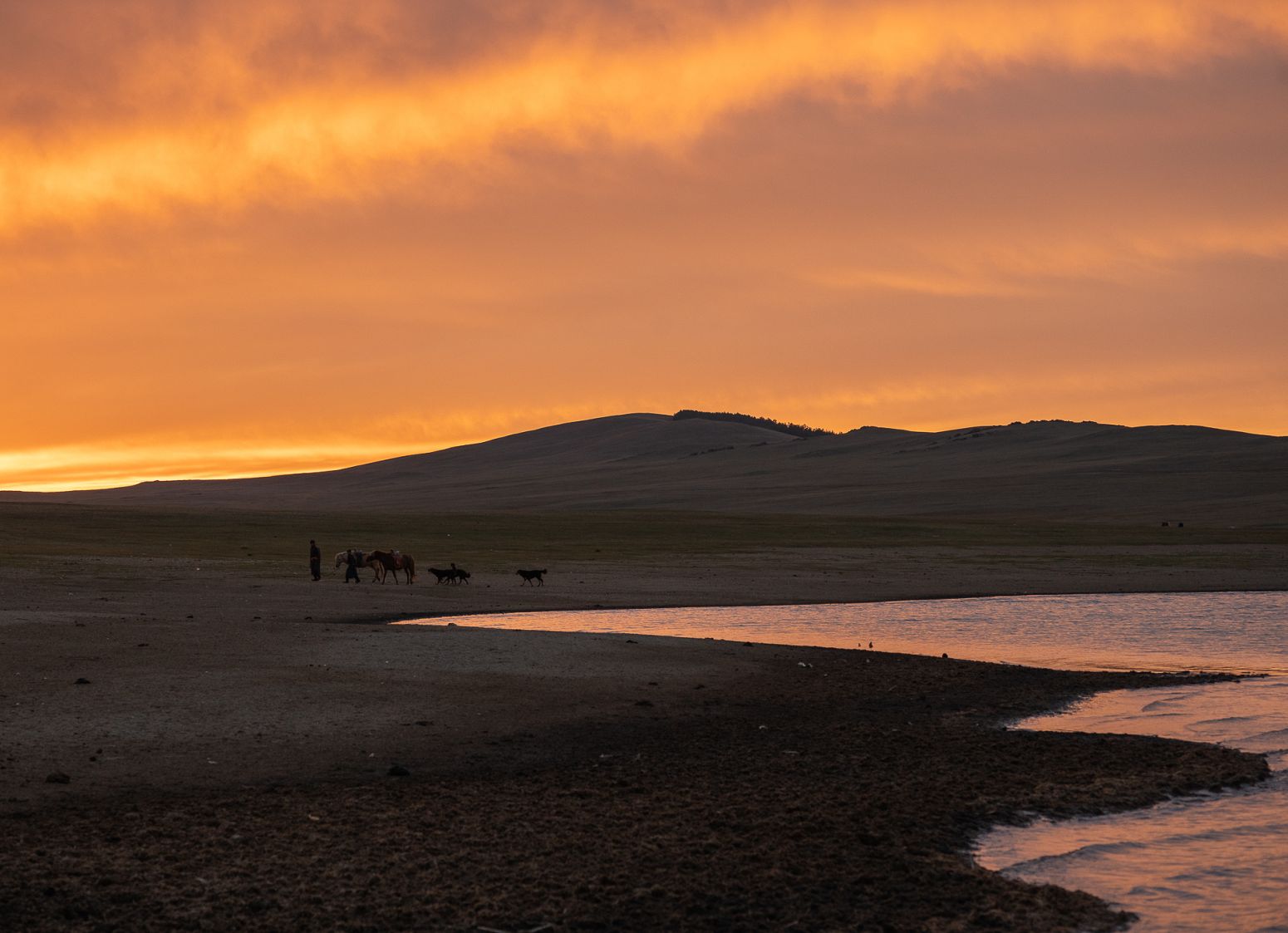 Mongolian nomad and his son near Tunamal lake , Mongolia