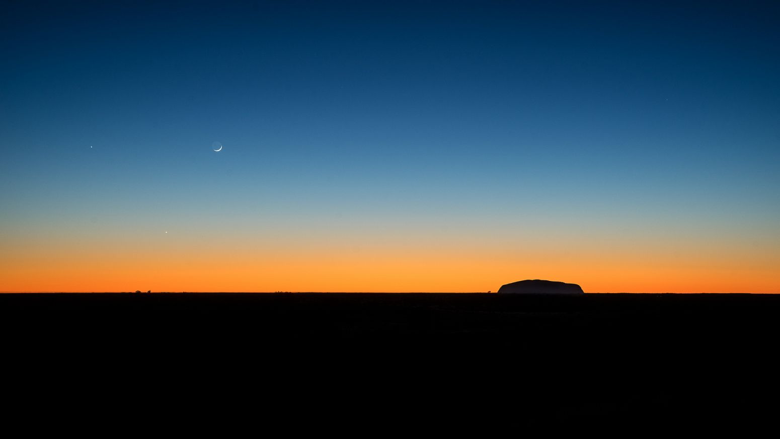 Uluru as seen from Kata Tjuta at sunrise, Northern Territory, Australia